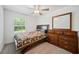 Bright bedroom with ceiling fan and large window at 17399 Nectar Flume Dr, Land O Lakes, FL 34638