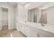 Bathroom with double sink vanity with a white countertop and tiled shower at 11720 Renaissance Blvd, Venice, FL 34293