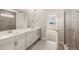 Bathroom featuring double sink vanity with quartz countertop and a glass enclosed shower at 11720 Renaissance Blvd, Venice, FL 34293