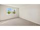 Bedroom with soft carpet flooring and two windows providing lots of natural light at 11720 Renaissance Blvd, Venice, FL 34293