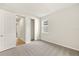 Carpeted bedroom with window and open closet at 11720 Renaissance Blvd, Venice, FL 34293