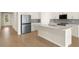 Modern kitchen with stainless steel appliances, a center island, and sleek countertops at 11720 Renaissance Blvd, Venice, FL 34293