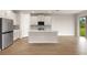 Bright kitchen with white cabinetry, stainless steel appliances, and a center island at 11720 Renaissance Blvd, Venice, FL 34293