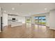 Spacious open-concept living area with modern kitchen and sliding glass doors to the lanai at 11720 Renaissance Blvd, Venice, FL 34293