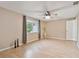 Light and airy bedroom with wood floors, ceiling fan, and window at 1213 Abbey Crescent Ln, Clearwater, FL 33759