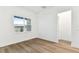 Bright and airy bedroom with hardwood floors, a large window with a view, and neutral walls at 1650 Fallon Pass, Zephyrhills, FL 33541