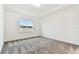 Bright bedroom with neutral carpet, base trim and a large window offering natural light at 1650 Fallon Pass, Zephyrhills, FL 33541