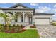 Charming single-story home with a covered front porch, paver driveway, and well-maintained landscaping at 1650 Fallon Pass, Zephyrhills, FL 33541