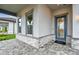 Inviting front entrance with stone accents, a glass-paneled door, and a gray-trimmed window at 1650 Fallon Pass, Zephyrhills, FL 33541