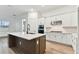 Well-appointed kitchen with white cabinets, stainless steel appliances, and island with stone countertop at 1650 Fallon Pass, Zephyrhills, FL 33541