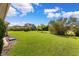 Large grassy backyard with lush landscaping and privacy at 9878 Sago Point Dr, Seminole, FL 33777