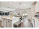 Open concept kitchen with island, stainless steel appliances, and white cabinetry at 6611 Devlin Ln, Wesley Chapel, FL 33545