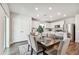 Bright dining room with table and chairs, adjacent to kitchen at 6611 Devlin Ln, Wesley Chapel, FL 33545