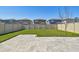 Large backyard with patio and grassy area at 6611 Devlin Ln, Wesley Chapel, FL 33545