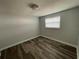 Simple bedroom with gray walls and wood-look floors at 1024 Jadewood Ave, Clearwater, FL 33759
