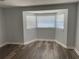 Spacious bedroom with bay window and laminate wood flooring at 1024 Jadewood Ave, Clearwater, FL 33759