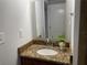 Bathroom features granite vanity top and a large mirror at 1024 Jadewood Ave, Clearwater, FL 33759