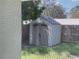 View of backyard shed through screen door at 1024 Jadewood Ave, Clearwater, FL 33759