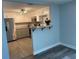 Modern kitchen features granite countertops, stainless steel appliances, and gray cabinets at 1024 Jadewood Ave, Clearwater, FL 33759