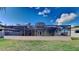 Spacious screened pool area with brick pavers and large backyard at 6969 Oldgate Cir, New Port Richey, FL 34655