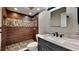 Bathroom with dark wood tile and pebble flooring at 6969 Oldgate Cir, New Port Richey, FL 34655
