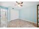 Light blue bedroom with tile flooring and double door closet at 6435 Thicket Trl, New Port Richey, FL 34653