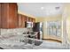 Modern kitchen with stainless steel appliances and granite countertops at 6435 Thicket Trl, New Port Richey, FL 34653