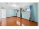 Bright bedroom featuring wood flooring and light blue walls at 6435 Thicket Trl, New Port Richey, FL 34653