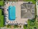 Community pool with surrounding lounge chairs and adjacent cabana at 6435 Thicket Trl, New Port Richey, FL 34653