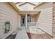 Covered entryway with white railings and a walkway leading to the front door at 6435 Thicket Trl, New Port Richey, FL 34653