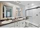 Bathroom with double vanity, granite countertops, and shower at 6435 Thicket Trl, New Port Richey, FL 34653