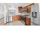 Modern kitchen with stainless steel appliances and granite countertops at 6435 Thicket Trl, New Port Richey, FL 34653