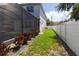 Landscaped side yard with privacy fence at 3515 W Paxton Ave, Tampa, FL 33611