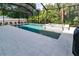 Inviting pool and spa with gray pavers and lush landscaping at 3515 W Paxton Ave, Tampa, FL 33611