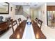 Bright dining room with a dark wood table and chairs, adjacent to the kitchen at 3515 W Paxton Ave, Tampa, FL 33611