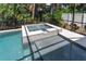 Relaxing screened pool and spa with tiled coping and spacious deck at 3515 W Paxton Ave, Tampa, FL 33611