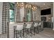 Community bar with seating and a stone accent wall at 11720 Renaissance Blvd, Venice, FL 34293
