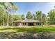 View of the home's exterior showing the covered patio and large backyard at 22426 Golden Retriever Ln, Brooksville, FL 34601