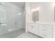 Clean, bright bathroom with glass-enclosed shower and double vanity at 22426 Golden Retriever Ln, Brooksville, FL 34601