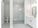 Modern bathroom with glass shower, sleek vanity, and neutral tones at 22426 Golden Retriever Ln, Brooksville, FL 34601
