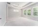 Spacious bedroom with tray ceilings, large windows offering natural light, and freshly painted walls at 22426 Golden Retriever Ln, Brooksville, FL 34601