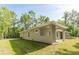 Exterior view of the house showing covered patio and neat lawn at 22426 Golden Retriever Ln, Brooksville, FL 34601