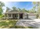 Charming single story home with a brick driveway, well manicured lawn and appealing entrance at 22426 Golden Retriever Ln, Brooksville, FL 34601