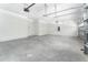 Bright garage featuring painted walls and ceiling, two doors to the house, and an electric box at 22426 Golden Retriever Ln, Brooksville, FL 34601