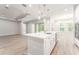 Open kitchen featuring a center island, modern appliances, and seamless flow to the dining area at 22426 Golden Retriever Ln, Brooksville, FL 34601