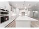Bright, modern kitchen with white cabinets, an island, and stainless steel appliances at 22426 Golden Retriever Ln, Brooksville, FL 34601
