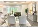 Bright living room with modern furniture, adjacent to the dining area at 22426 Golden Retriever Ln, Brooksville, FL 34601