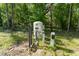 View of the well system with its components in a wooded, grassy area of the property at 22426 Golden Retriever Ln, Brooksville, FL 34601