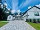 Charming single-story home featuring a brick driveway and modern farmhouse architecture at 4000 Southern Valley Loop, Brooksville, FL 34601