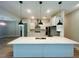 Bright, open kitchen with a large island, stainless steel appliances, and stylish pendant lighting at 4000 Southern Valley Loop, Brooksville, FL 34601